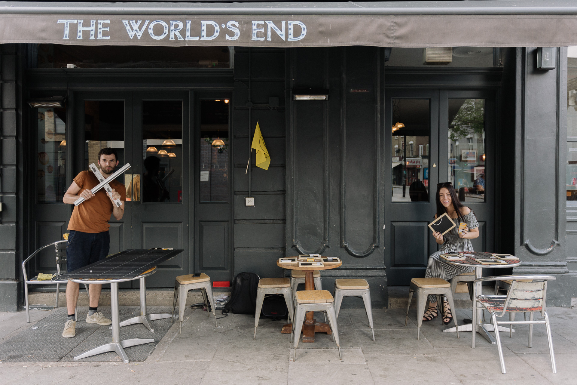 Two people outside The World's End Pub in Stroud Green.