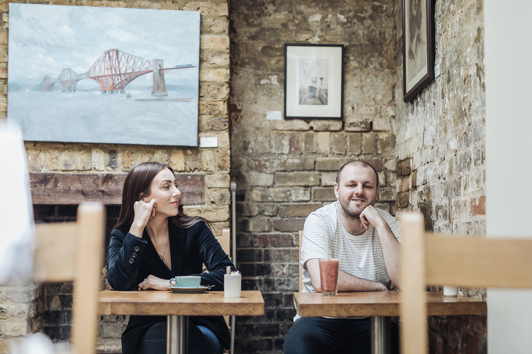 Claire, owner of locally based brand design and creative studio Barefaced Studios with her co-worker in a local cafe in Stroud Green.