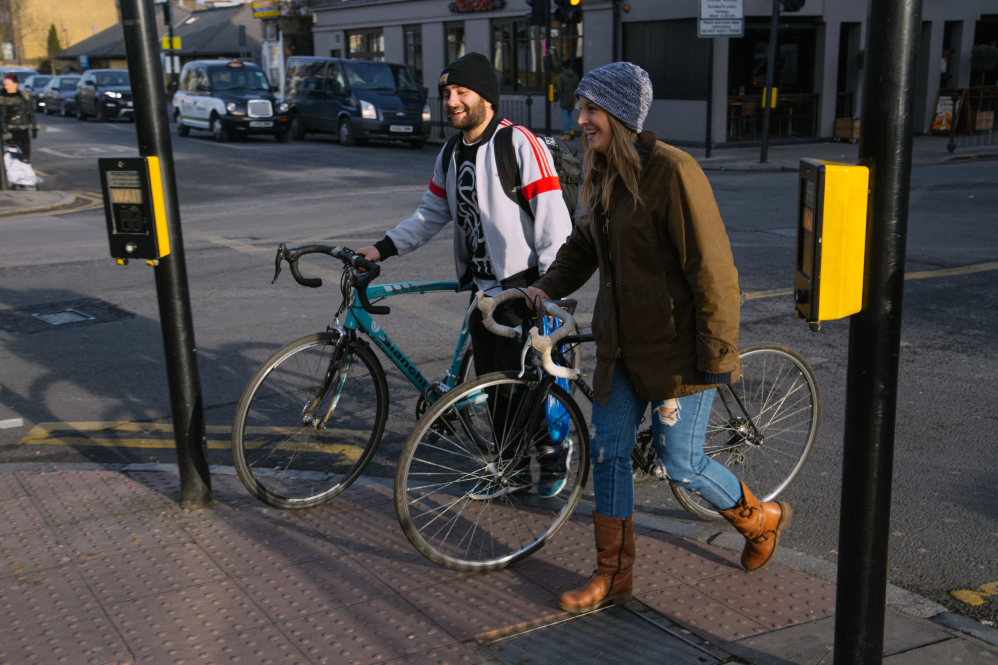 A couple cycling through Stroud Green in North London