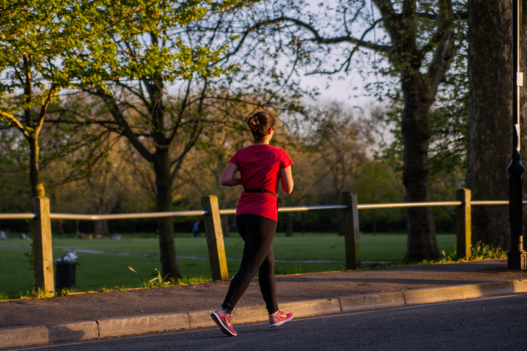 A woman running in a green space in North London