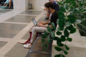 A man on his laptop gathering sorting through digital files