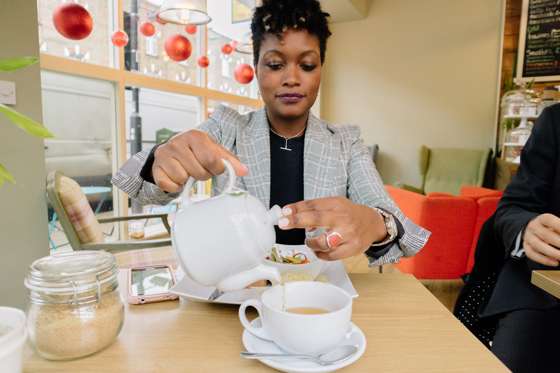 A Davies & Davies employee pouring coffee in a local cafe.