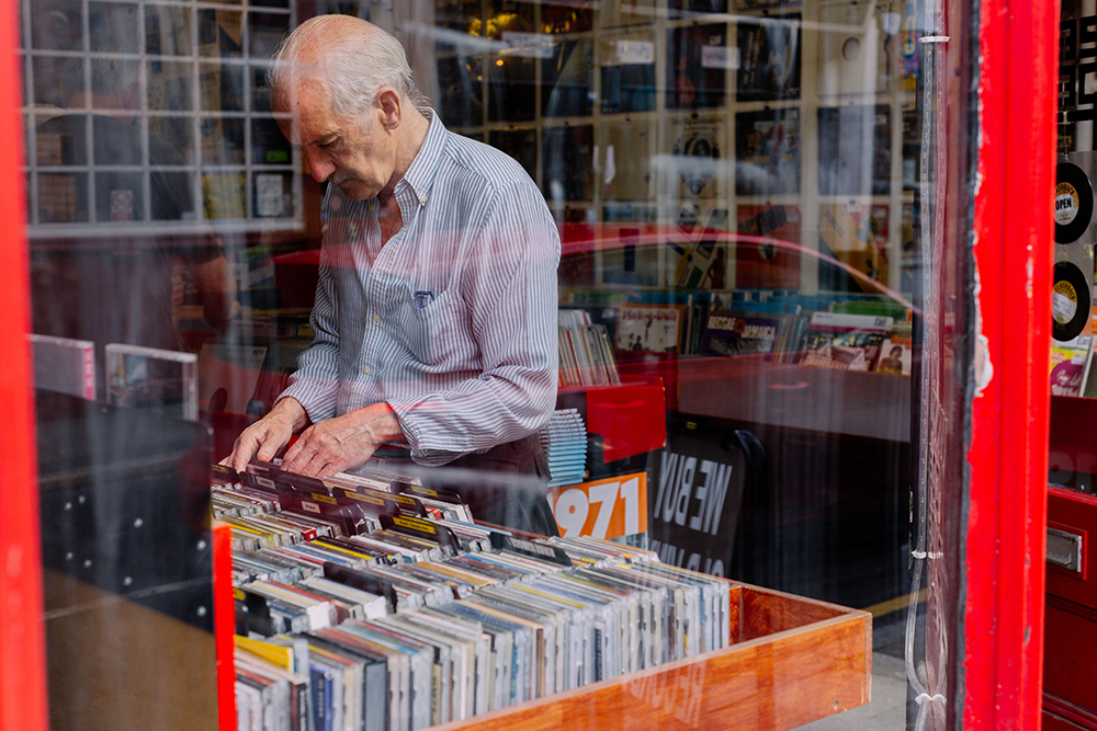 A man looking through records in a local record store in Crouch End.