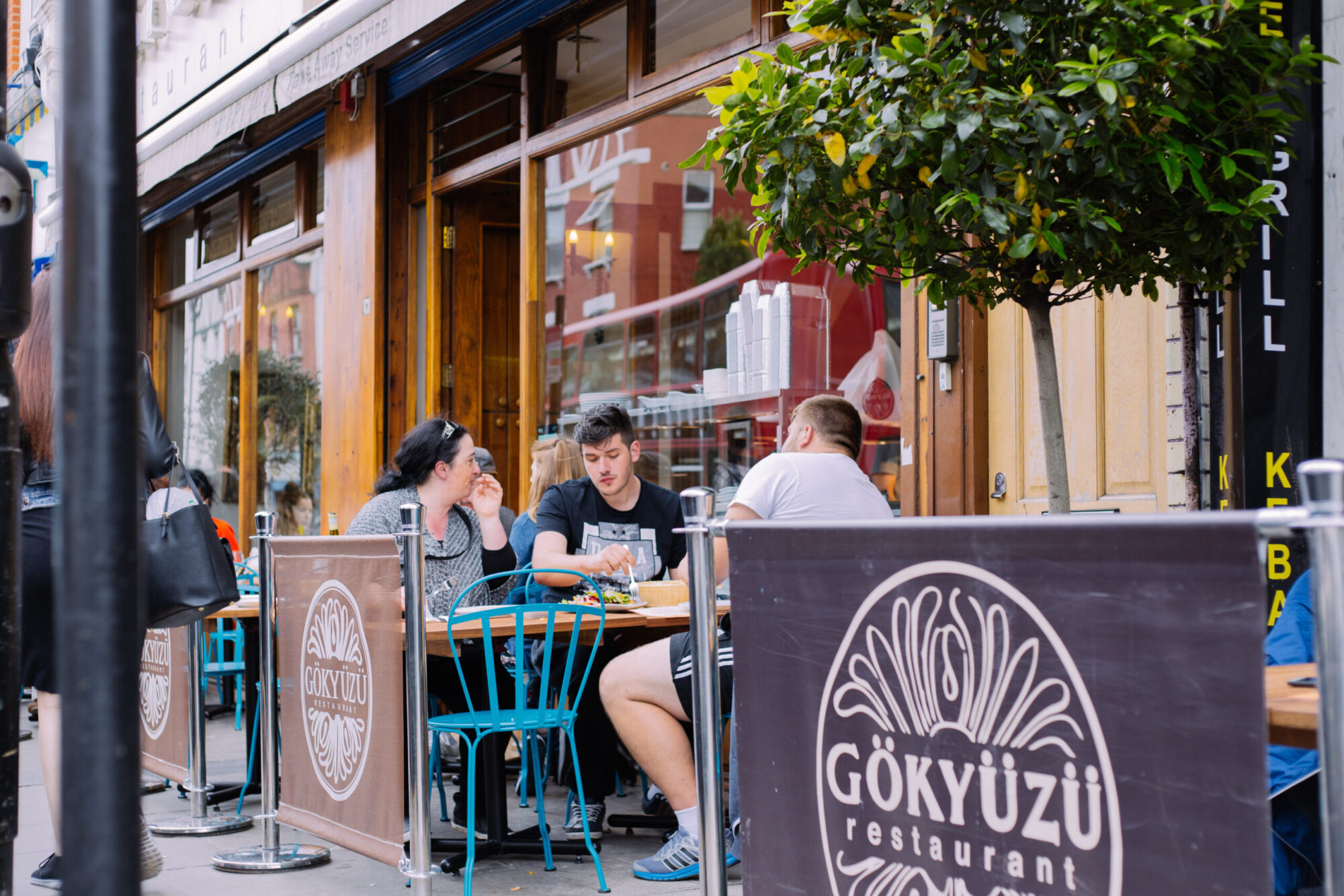 People eating in the outside area of Gokyuzu, a Turkish restaurant in Harringay.