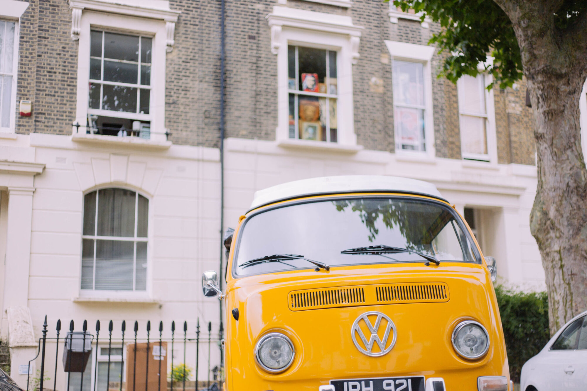 A yellow campervan on a residential road in Holloway.