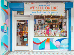 The outside of Pretty Shiny Shop with a banner saying "We Sell Online"