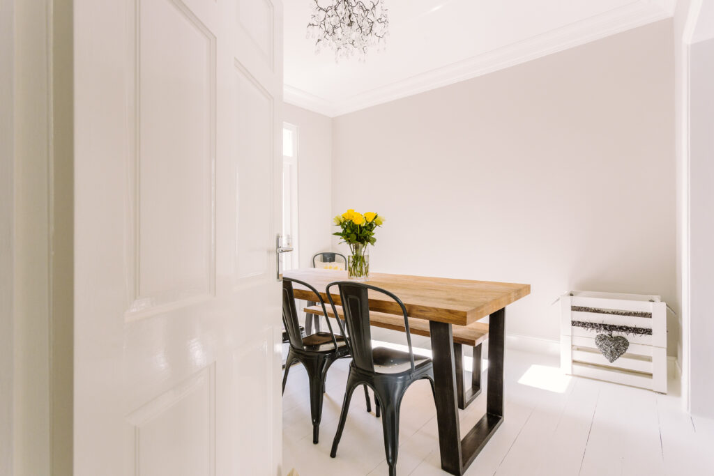 A photo of dining room that's appearance is spotlessly clean - everything is perfectly placed like a show home.