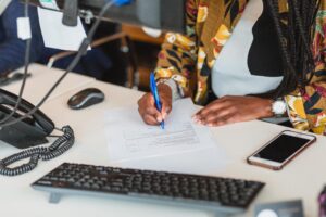 Photo of a member of Davies & Davies filling out a sales property valuation form with a prospective seller.