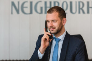 Photo of a member of Davies & Davies team calling a Landlord to confirm they rental property has new tenants. 